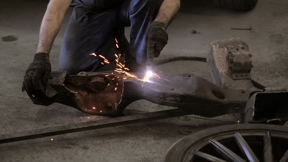 Workman Cuts Iron Details Via Plasma Cutter
