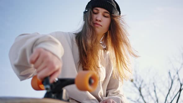Bottom View Close Up Portrait of Young Beautiful Female Skater alt