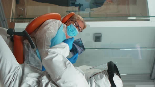 Vertical Video Stomatologist in Protective Suit Asking for Dental Xray alt