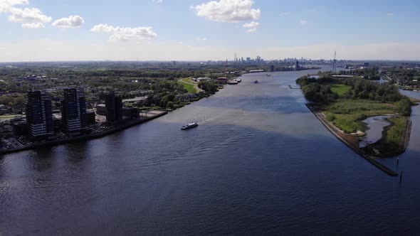 Aerial View Of Boat Cruising At Nieuwe Maas River Near Kinderdijk In Netherlands. - aerial alt