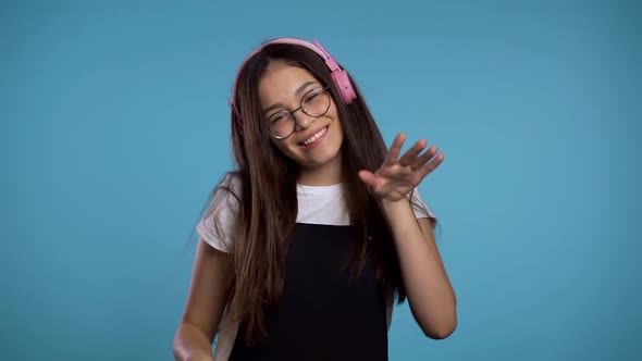 Pretty Young Asian Girl Having Fun, Smiling, Dancing with Headphones in Studio alt