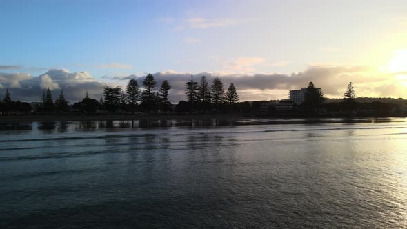 Waves rolling in at golden hour in Orewa alt