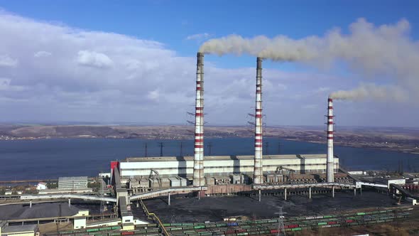 Aerial View of Old Thermoelectric Plant with Big Chimneys in a Rural Landscape Near the Reservoir alt