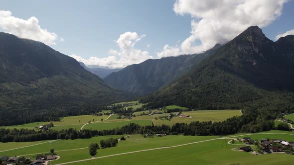 Aerial view of the village, fields and forest in mountains Alps Austria alt
