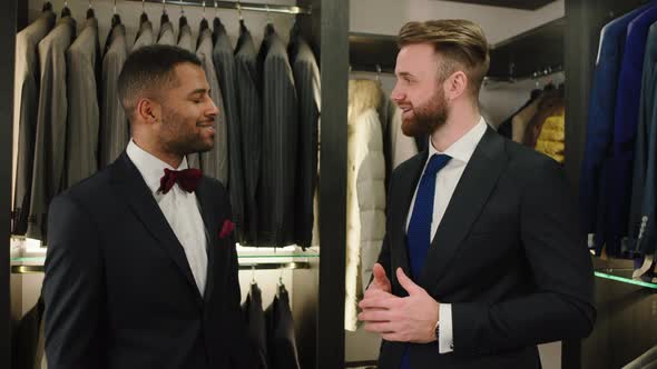 Discussing Two Businessmen in the Luxury Suit Shop