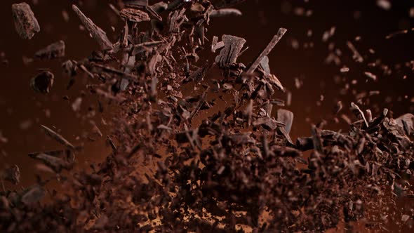 Super Slow Motion Shot of Raw Chocolate Pieces and Cocoa Powder After Being Exploded at 1000Fps alt