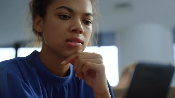 Businesswoman Looking at Smartphone Screen alt