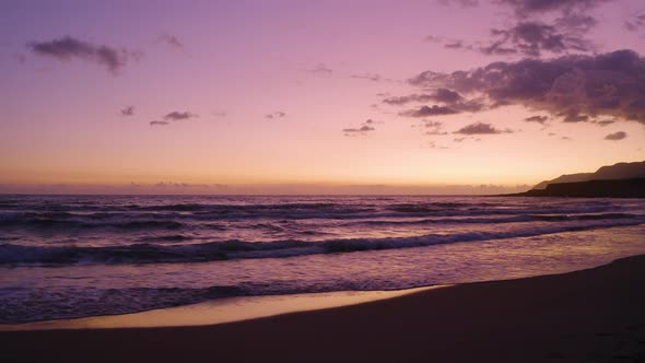 Aerial view of Romantic Evening in the Sea. Flying over beach at Purple Sunset.  alt