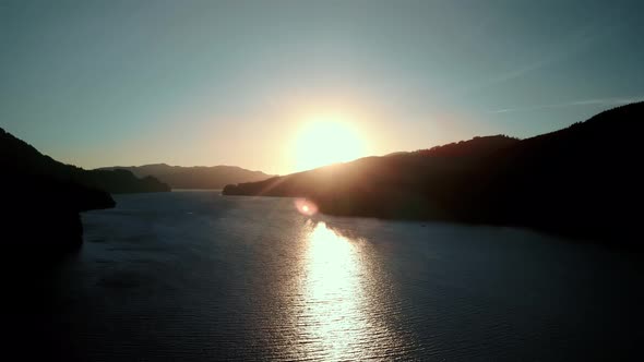 Bird'seye View of the Sunrise Over the River with Hilly Terrain alt