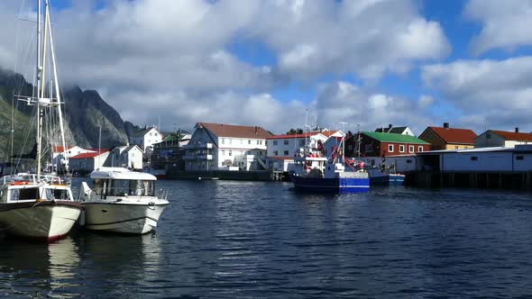 Fishing boat passing by at the village Henningsvaer alt