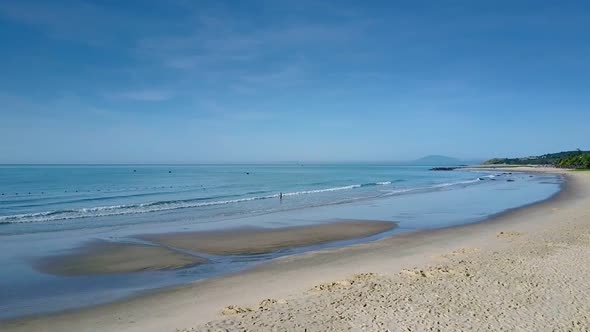 Sand Beach Woman Goes To Clean Sea Under Serene Sky alt