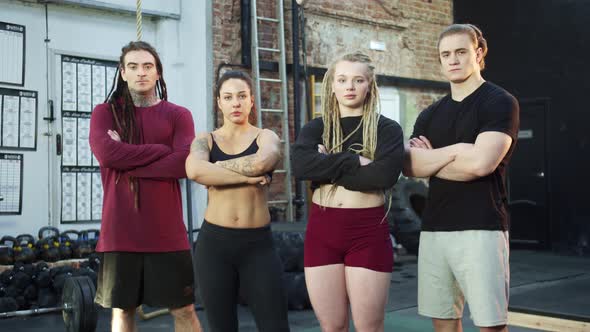 Four Athletes are Posing for the Camera alt