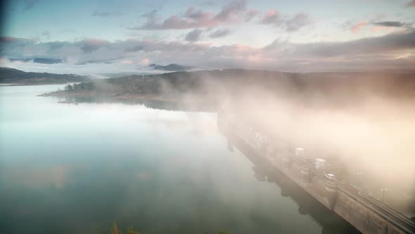 Morning Fog Over Dam On Embalse De Aguilar De Campoo, Spain. alt