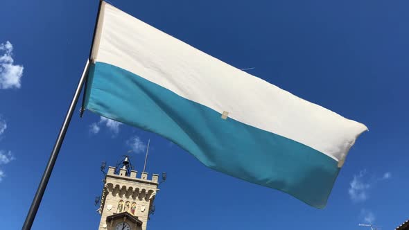 Flag of SanMarino Fluttering in the Wind with Blue Sky on the Background alt