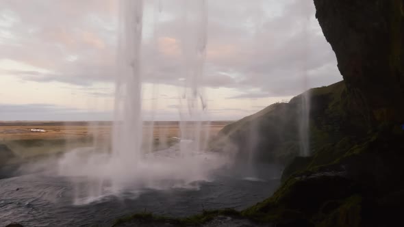 Super Slow Motion Behind of Seljalandsfoss Waterfall at Dudk