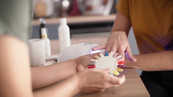 Close up video of two women choosing nail color. Shot with RED helium camera in 8K alt
