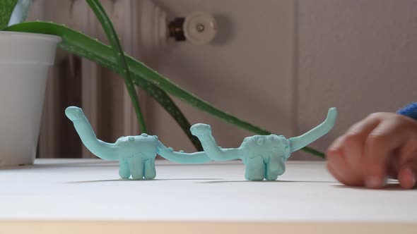 Child And Mom Play With Dino Clay