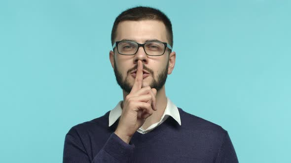 Slow Motion of European Guy in Glasses Asking to Keep Quiet Shushing at Camera Make Hush Gesture