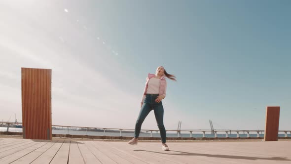 Young Woman Dancing on Deck alt