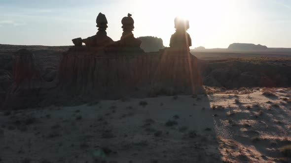 Scenic Aerial of Goblin Valley Nature Park with Sunrise Behind Red Rocky Peaks alt