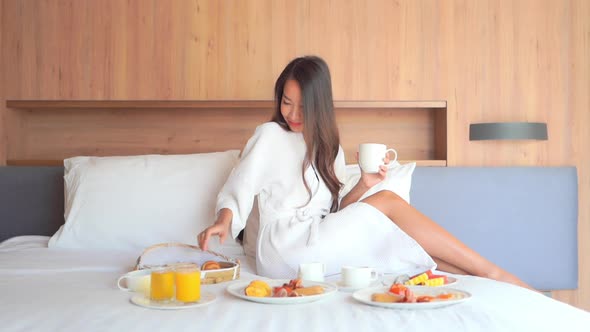 Young asian woman breakfast on bed