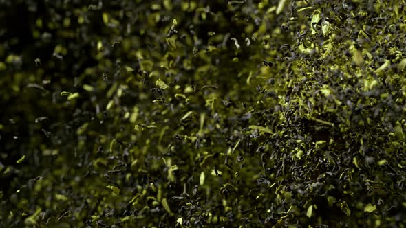 Super Slow Motion Shot of Falling Dried Tea Isolated on Black Background at 1000Fps alt