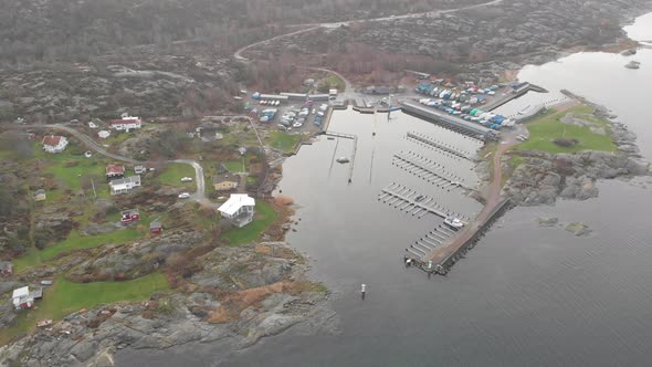 Empty Small Town Harbour at West Coast of Sweden Aerial Forward alt
