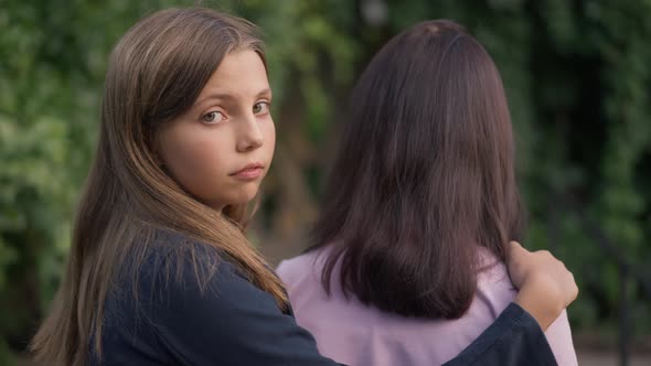 Cute Confident Teenage Girl Turning Looking at Camera Holding Friend Shoulder alt
