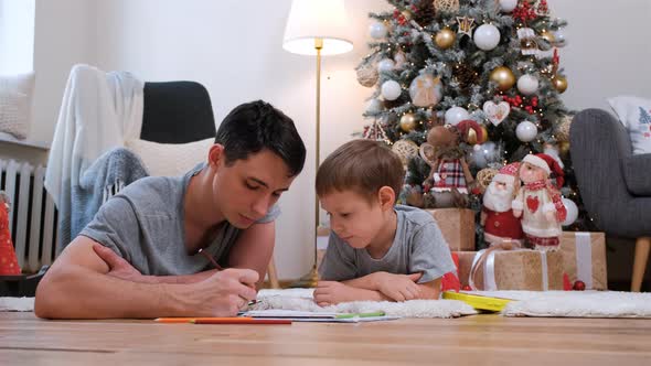 Little Boy with Dad Drawing Near Christmas Tree alt