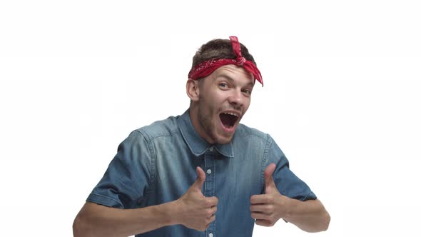 Excited Handsome Young Bearded Man with Red Headband Jumping From Bottom with Thumbsup Then Waving