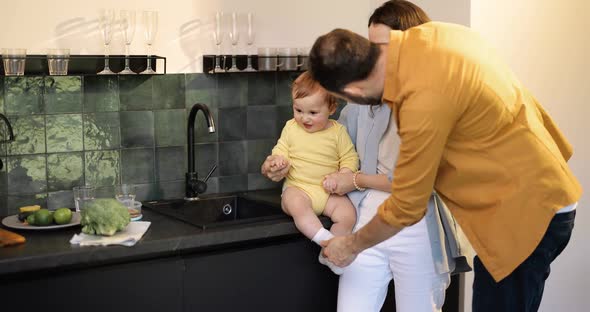Happy Family with a Kid on a Kitchen at Home alt