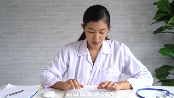 Online Video Conference Chat with Asian Female Doctor and Patient While Diagnosing Looking at Camera alt