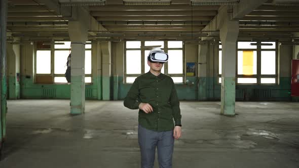 An Engineer Wearing Virtual Reality Glasses Moves Digital Objects with His Hands alt