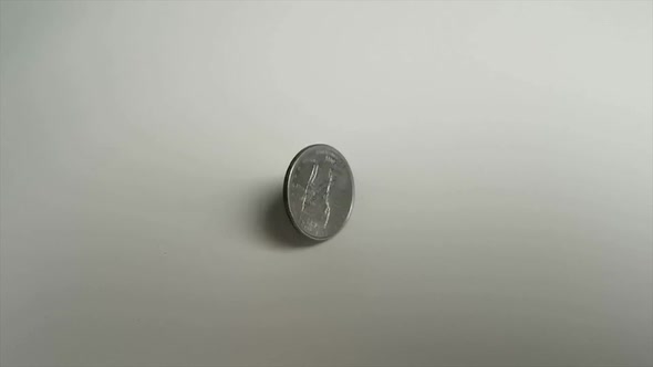 Quarter Dollar 25 Cent Coin Rotating Over White Background 1000 Fps Super Slow Motion Video alt
