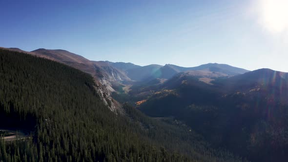 Aerial 4k wide shot. Drone flying over scenic fall colors in the Colorado Rocky Mountains.