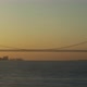 A boat view of an ocean bridge and a city port at sunset. - VideoHive Item for Sale