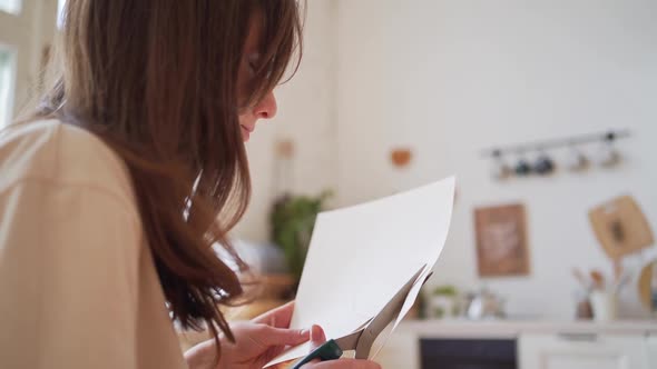 The Person Cuts the Valentine with Scissors From the Paper alt