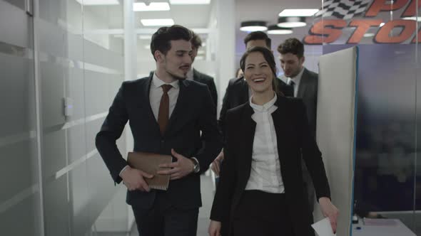 Happy people walking through the office building alt