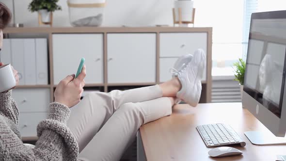 Young Woman Procrastinates Scrolling her Smartphone alt
