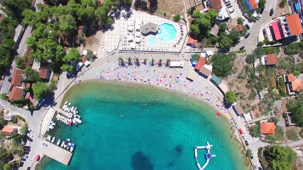 Flying above touristic apartments at white sandy beach of Solta island, Croatia alt