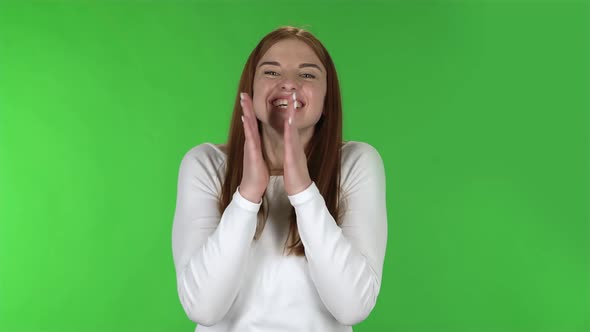 Portrait of Pretty Young Woman Is Clapping Her Hands with Wow Happy Joy. alt