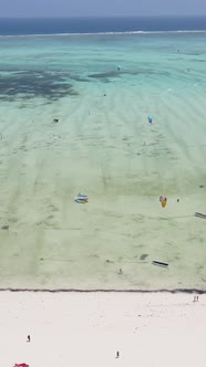 Vertical Video Kitesurfing Near the Shore of Zanzibar Tanzania alt