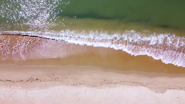 Small sea waves. Soft waves on a sandy beach. Seascape background