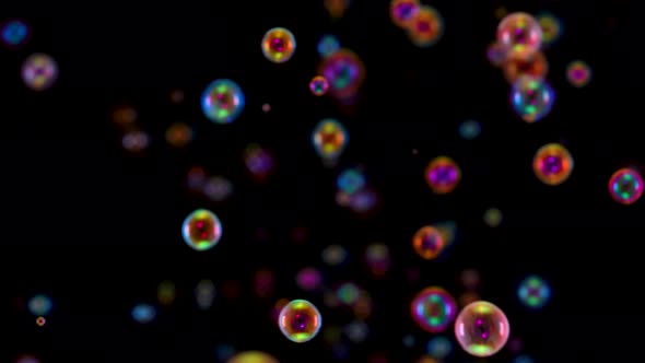 Blurred Footage of Beautiful Colorful Rainbow Soap Bubbles Flying in the Air Against a Black alt