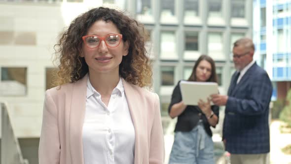 Portrait of a Middleaged Businesswoman in the Courtyard of a Large Business Center alt