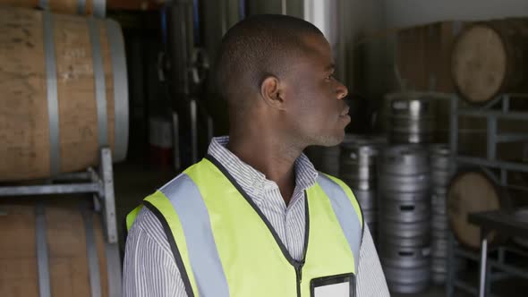 African American man smiling at camera and wearing high visibility vest alt
