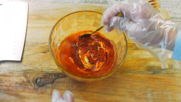 The Chef Mixes the Ingredients for the Honey and Mustard Sauce with a Golden Spoon alt