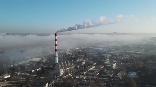 Aerial drone view of industrial smoke coming from pipe factory tube. City pollution idea alt
