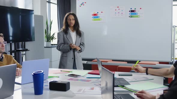 African American Young Woman Tells Colleagues at the Blackboard Business Ideas alt