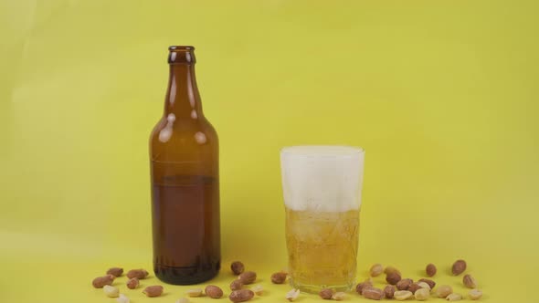 Beer in a glass on a yellow background. alt